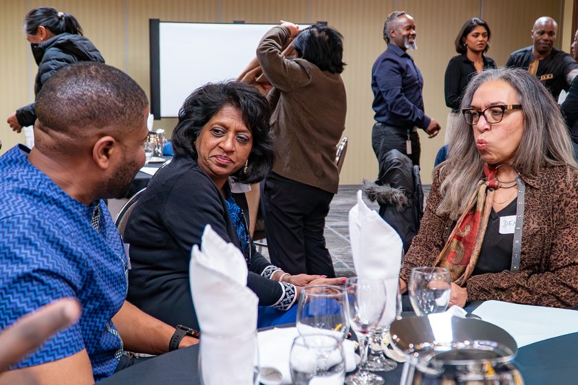 TINIA community members seated together in conversation at a community event